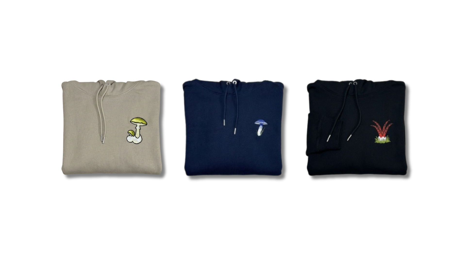 Three folded hoodies in different colors with embroidered designs on a white background